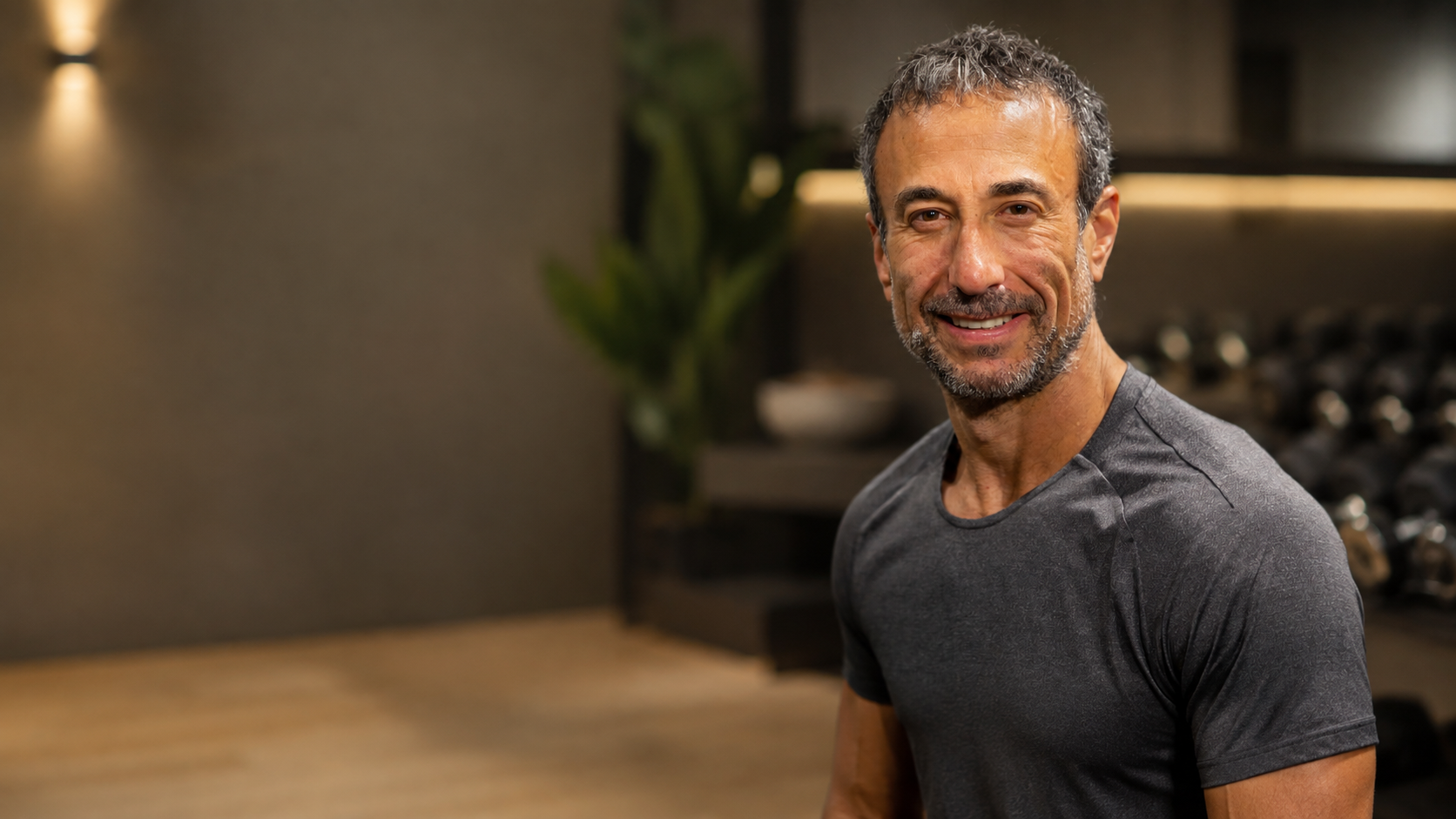 Brad Beracha, founder of B-Optimal Health, smiling in a training studio